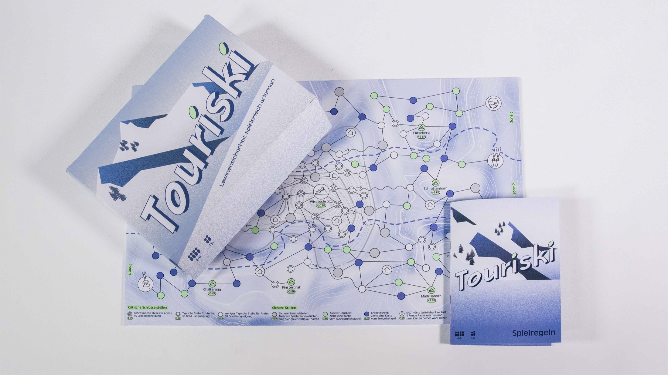 Touriski avalanche-safety game cards spread out on a table
